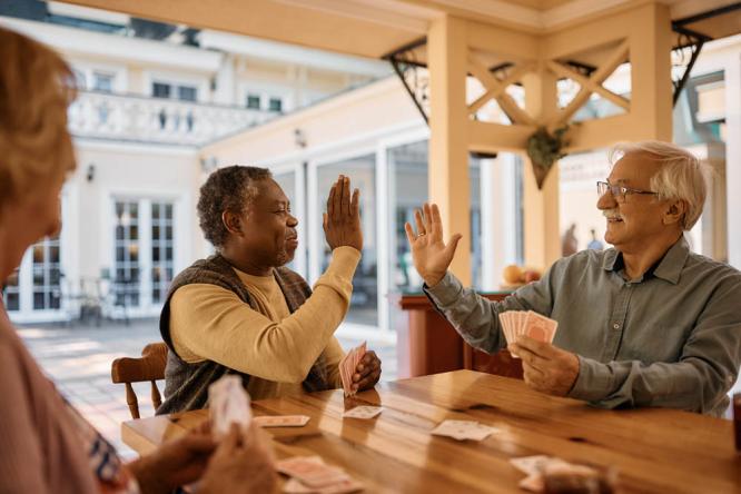 A caregiver and resident enjoying a card activity